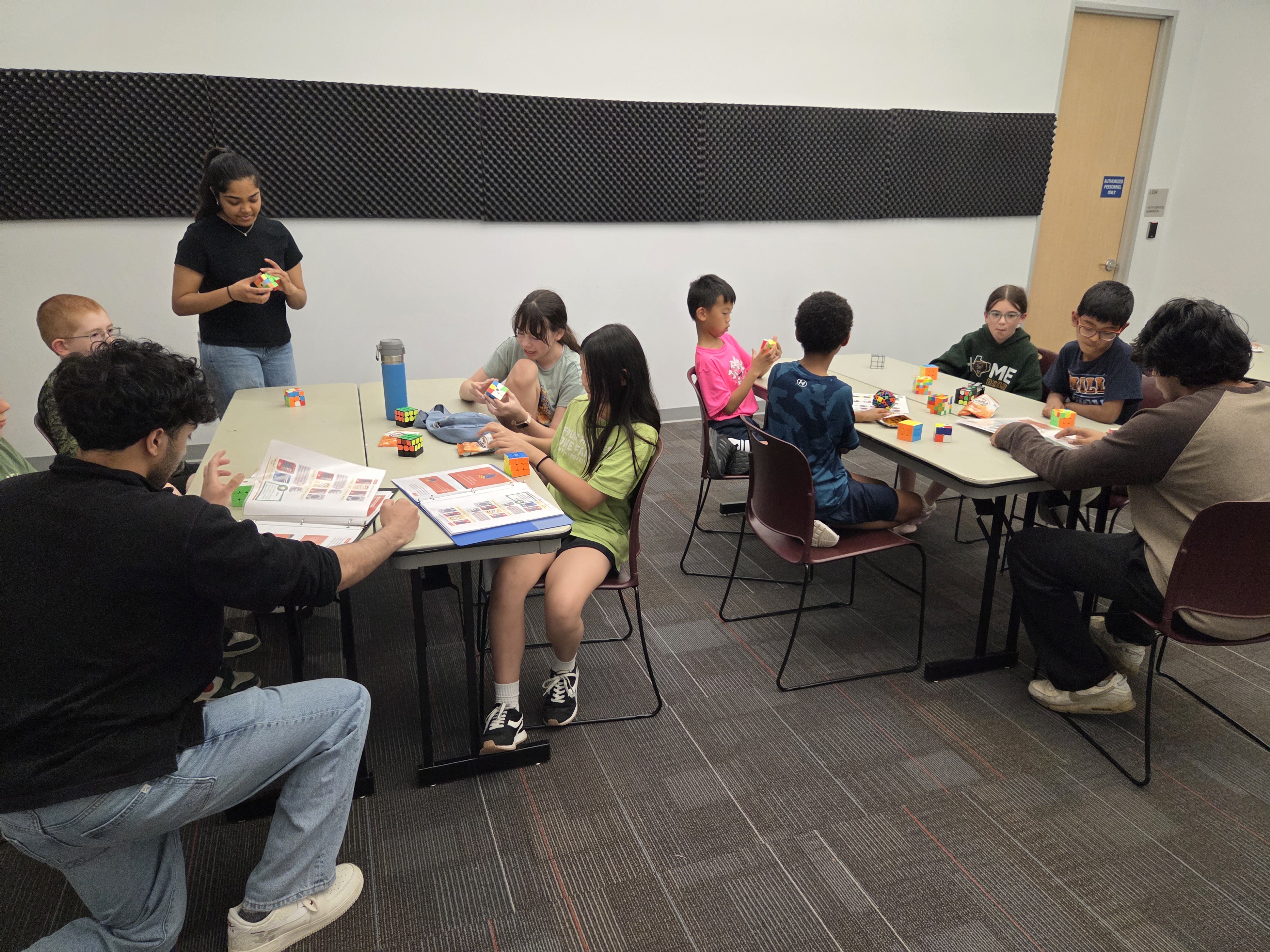 Students comparing cubes mid-session